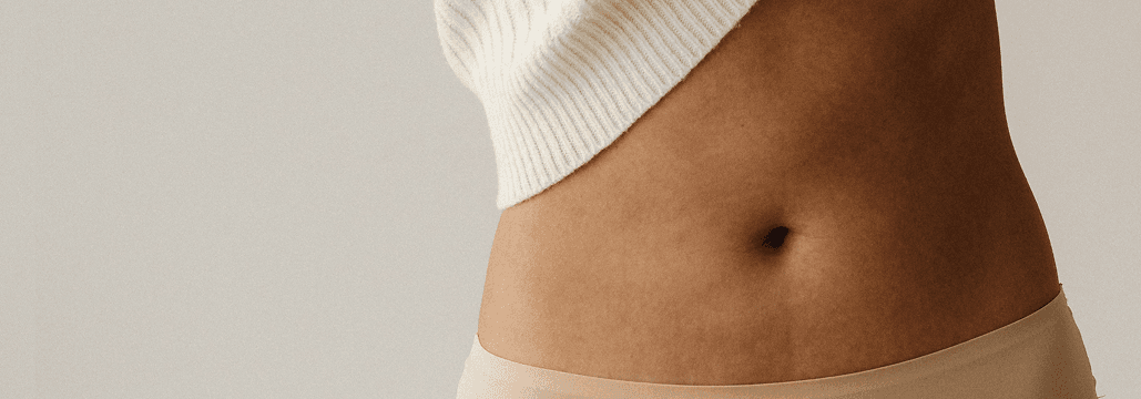 Person's midsection showing belly button and lower abdomen