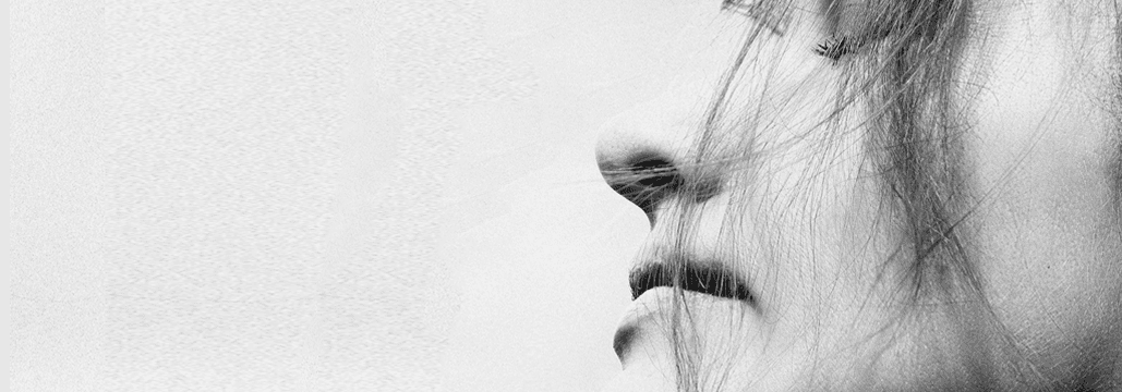 Black and white profile shot of person looking contemplative