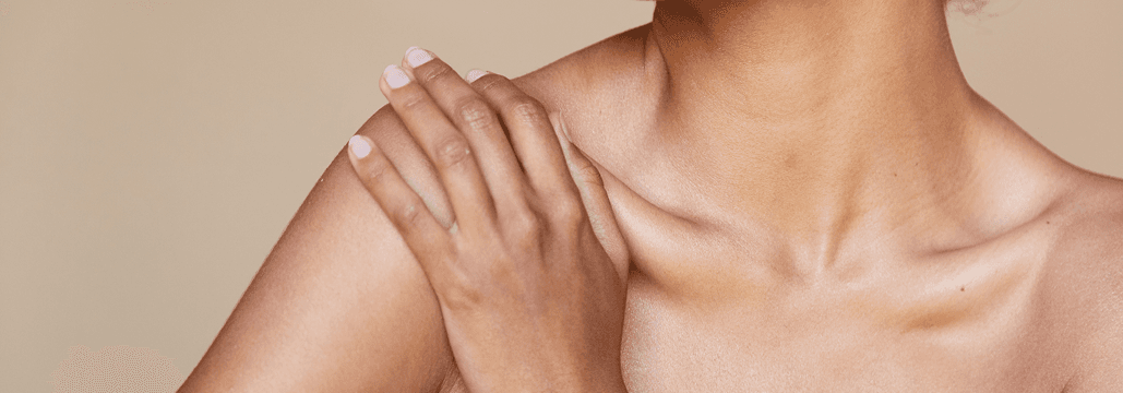 Close-up of person's shoulder with hand gently resting on it